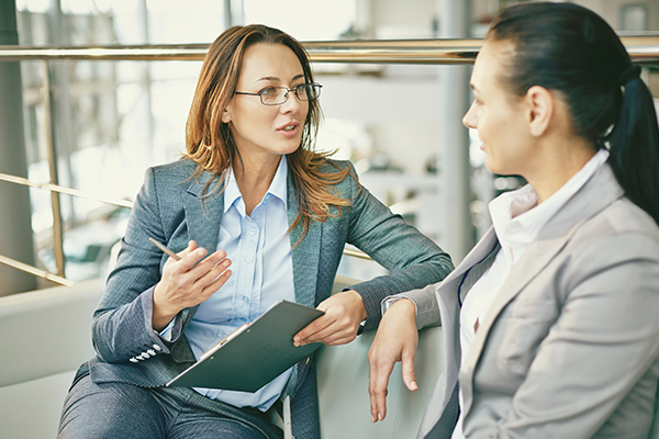 two people sitting together having a discussion