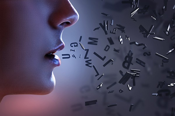 person with letters floating in the air, near mouth