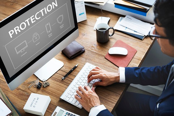 photo from above a person's desk showing computer screen with the word "protection"