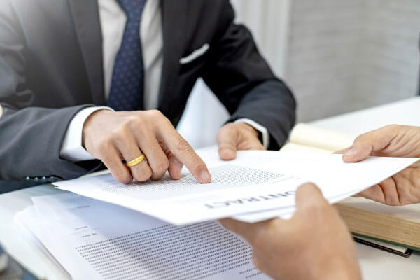 person handing over a contract