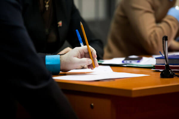 people sitting at table with documents