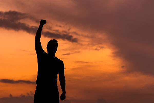 person standing with hand raised in a fist