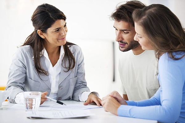 three people looking at document on a table