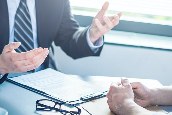 man speaking to client, only shows hands