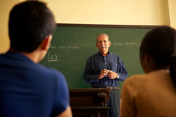 professor standing at the front of a classroom