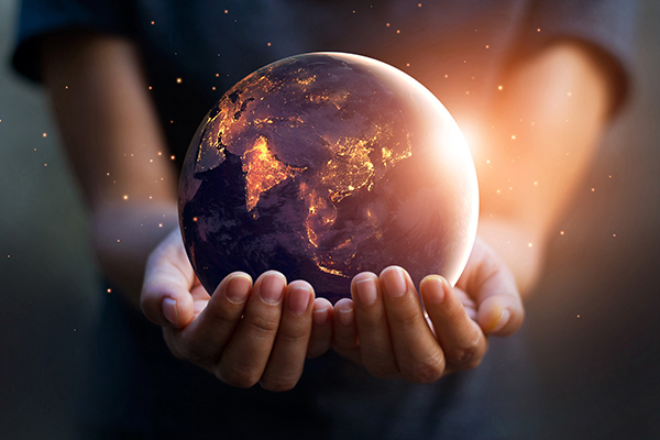 person holding a world in their hands