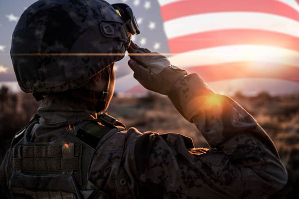 Female Solider Saluting US Flag at Sunrise